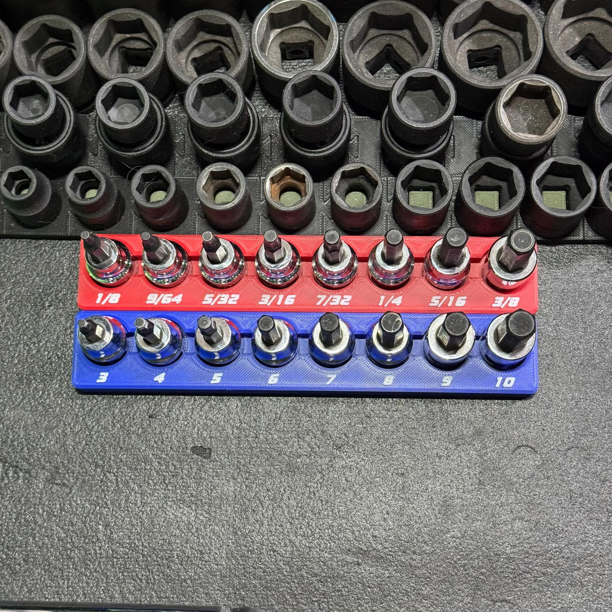 Top view of blue metric and red SAE hex bit socket holders with white size labels.