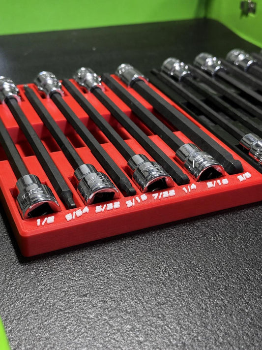 Long hex bit sockets laid flat in a red organizer with white size labels.