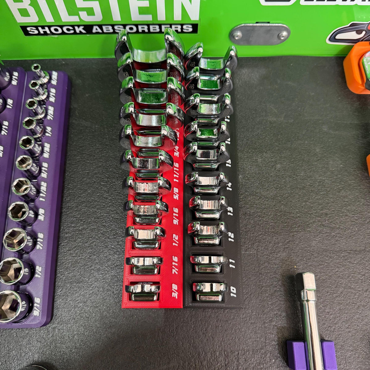 Overhead view of two narrow crowfoot wrench holders, red and black, with tools increasing in size along each row.